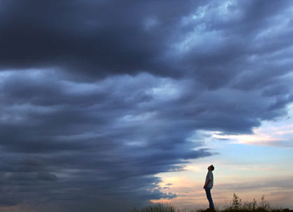 Man facing storm clouds